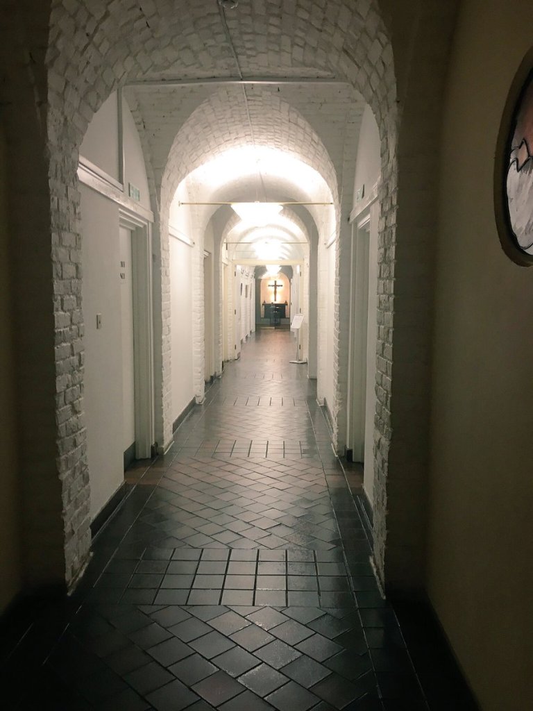 hallway with cross crucifix at end