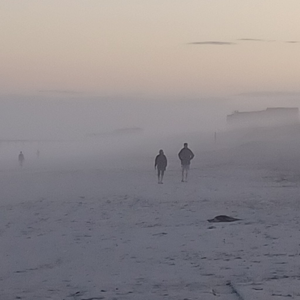 Misty beach walkers